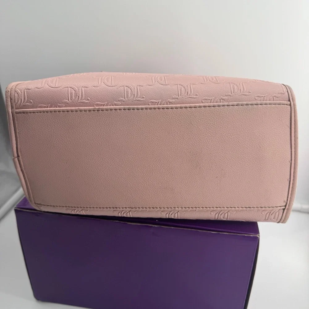 Y2K Juicy Couture satchel in pink, features an all-over embossed 